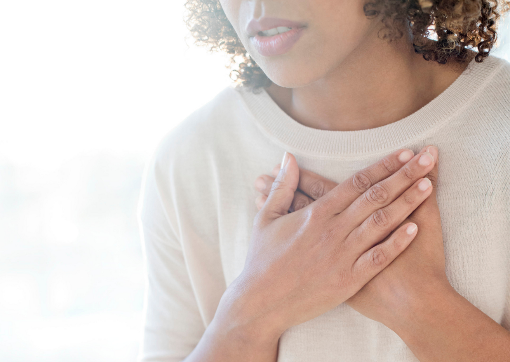 woman clutching chest out of breathlessness